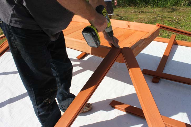 man assembling a gazebo roof